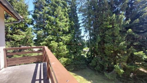 a balcony with a view of a forest of trees at Les balcons du Haut-Forez in Chalmazel Jeansagniere