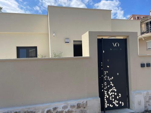 a black door with white butterflies on the side of a building at Luxury Villa Olga in Biograd na Moru