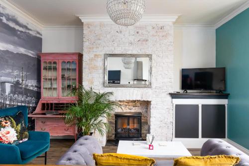 a living room with a fireplace and a tv at The Boat House Luxury Apartments Scarborough in Scarborough