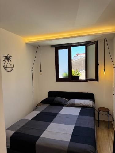 a bedroom with a bed and a window at Pozzallo sea house in Pozzallo