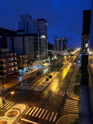 an empty city street at night with street lights at Cobertura 2Dorm Vista Mar e Serra in Capão da Canoa