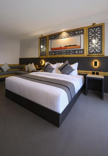 a large bedroom with a large white bed in it at Aroma Hotel in Aqaba