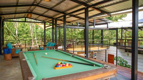 a pool table inside of a building with a roof at Four Trees Jungle Lodge in San Juan del Sur