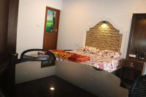 a bedroom with a bed with a brick wall at Heven of Breeze Idukki in Kūmudi