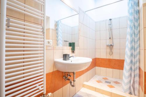a bathroom with a sink and a shower at Cedar Inn Budapest - Palace District in Budapest