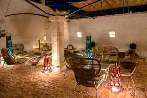 a group of chairs and lights in a room at Masseria Auraterrae in Polignano a Mare