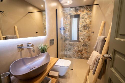 a bathroom with a sink and a shower at East Blue Luxury Apartment in Kamári