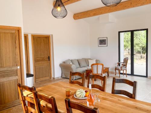 a living room with a table and a couch at Radegonde - Maison de charme avec piscine in Rustrel