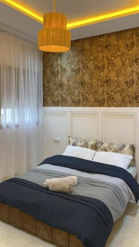 a bedroom with a large bed with a white towel on it at Appartement Orientale in Kenitra
