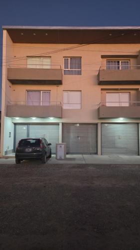 a car parked in front of a building at Paola in Trelew