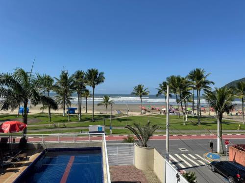 a view of the beach from the balcony of a resort at Pousada Cantinho Oriental in Bertioga