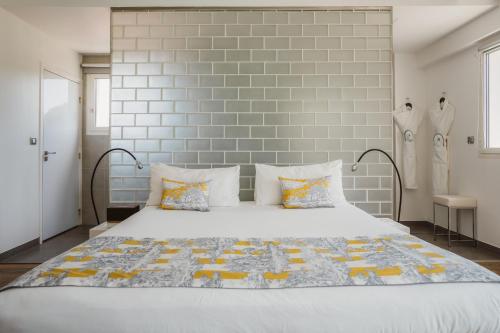 a bedroom with a large white bed with pillows at Kube Saint-Tropez in Saint-Tropez