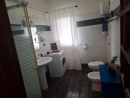 a bathroom with a sink and a toilet and a shower at La Casa di Piero in SantʼAngelo