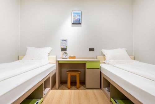 Katil atau katil-katil dalam bilik di Lemon Hotel Ningbo Tianyi Square Drum Tower Branch