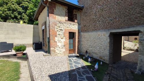 a brick building with chickens standing outside of it at La ferte in Olizy