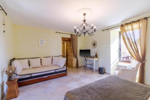 a living room with a couch and a table at Chambre d'hotes Les Clauzels in Proissans