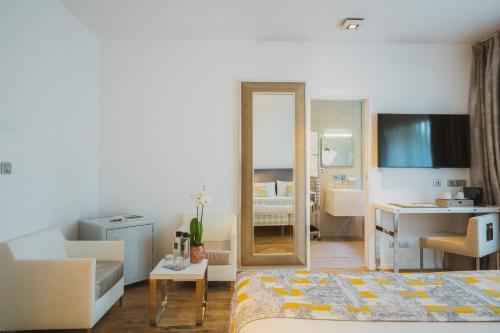 a bedroom with a mirror and a room with a bed at Kube Saint-Tropez in Saint-Tropez