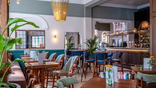 a restaurant with tables and chairs and a bar at Toll House Inn in Lancaster