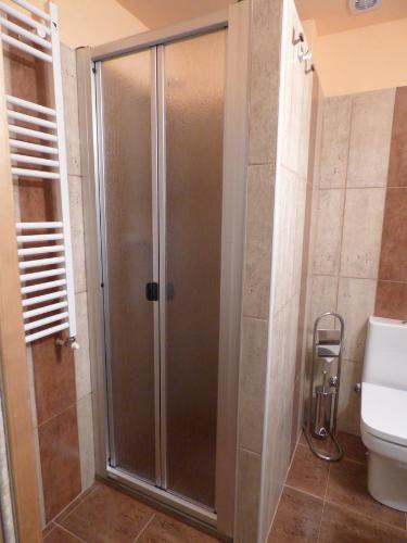 a shower with a glass door in a bathroom at Casa Atheba in La Iglesuela del Cid