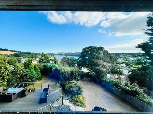 an aerial view of a park with a river and trees at Creek view house in Feock