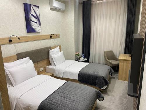 Postel nebo postele na pokoji v ubytování ART RESIDENCE Hotel