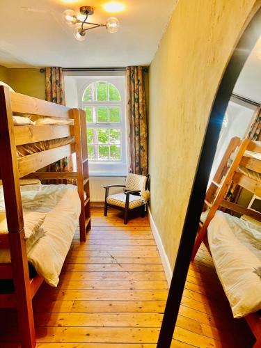 a room with two bunk beds and a window at Historic Rothbury Gem- West End House in Rothbury