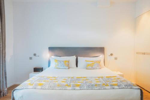 a bedroom with a large white bed with two pillows at Kube Saint-Tropez in Saint-Tropez
