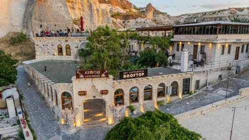 a model of a building with a mountain in the background at Kayatas Cave Suites in Goreme