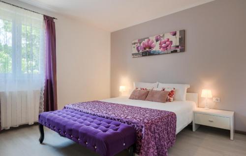 ein Schlafzimmer mit einem großen Bett mit einer lila Decke in der Unterkunft Villa Melnica by Villas Guide in Barban