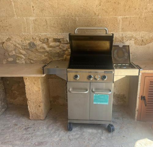 a kitchen with a stove and a counter with a grill at Villa Son Pons by Slow Villas in Llucmajor