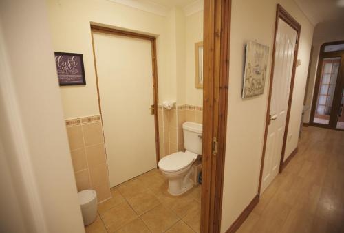 a bathroom with a toilet in a room at Woodlands in Newquay