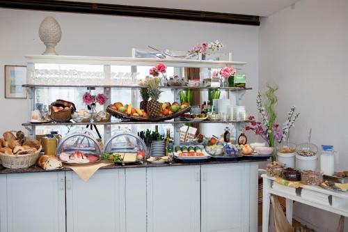 a shelf filled with lots of different types of food at Hotel Erbprinzenhof in Karlsruhe