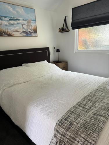 a bedroom with a white bed and a window at The West Wing in Bournemouth