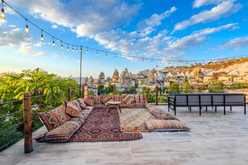 a patio with furniture and a view of a city at Kayatas Cave Suites in Goreme