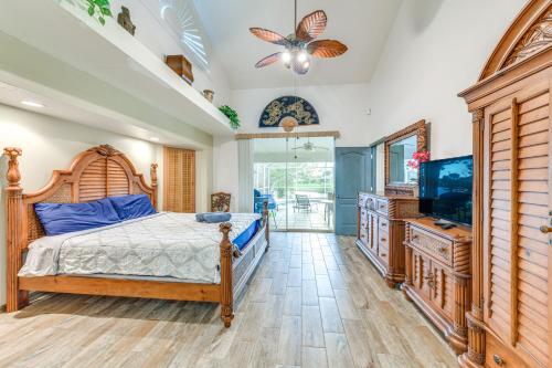a bedroom with a bed and a flat screen tv at Private Dock Waterfront Port Charlotte Oasis! in Port Charlotte