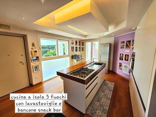 a kitchen with a stove top oven in a room at CasaVacanze Nichi vista mare in Grottammare