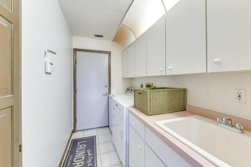 a kitchen with white cabinets and a sink at Private Dock Waterfront Port Charlotte Oasis! in Port Charlotte