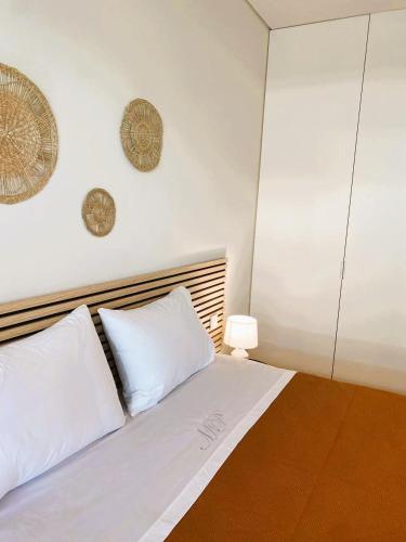 a white bed with two white pillows and a lamp at Beachside 2 BD Apartment | Balcony | AC in Vila Nova de Gaia