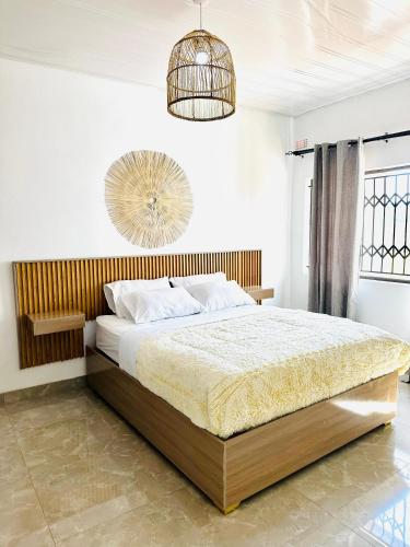 a bedroom with a large bed and a chandelier at Mulanje Vista House in Mulanje