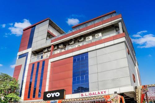 a building with aoc signage on the side of it at Hotel O S L Galaxy Yashoda Nagar in Juhi Bari
