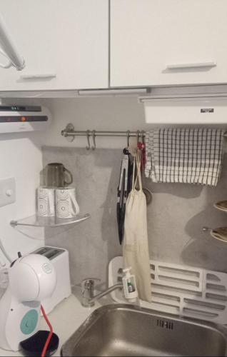 a kitchen with a sink and a counter top at Marine Guest House in Eastbourne