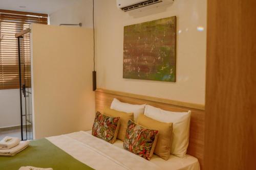 a hotel room with a bed with two pillows at Uva Rooms in Fethiye