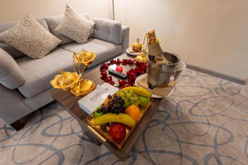 a tray of fruit on a table in a living room at Sumou Hotel Al Khobar in Al Khobar