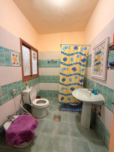 a bathroom with a toilet and a sink at Extra Traveller in Aqaba