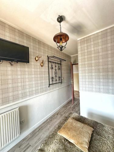 a living room with a tv on the wall at Willa Wydra in Krościenko