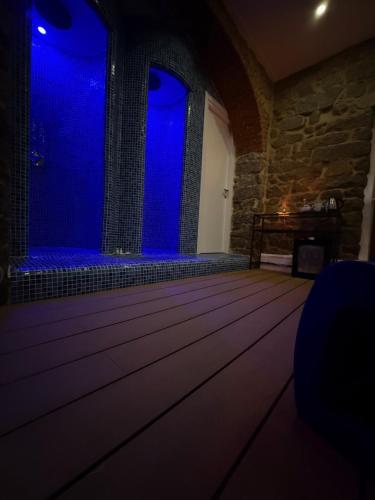 a dance floor with blue lights in a room at Exoria Luxury Rooms & SPA in Nuoro