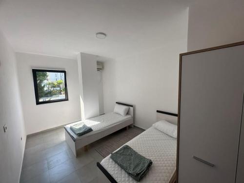 a small room with two beds and a mirror at Seaside 2-br flat with terrace in Golem