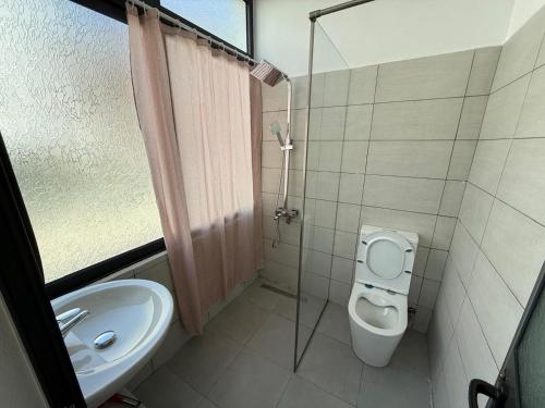 a bathroom with a toilet and a sink at Seaside 2-br flat with terrace in Golem