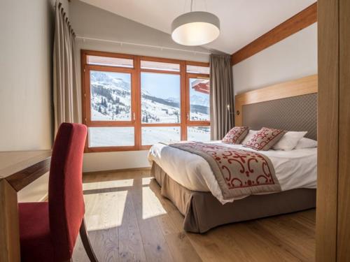 a bedroom with a bed and a table and a window at Appartement 5 pièces moderne avec piscine, spa, fitness, parking aux Arcs 1800 - FR-1-352-20 in Arc 1800
