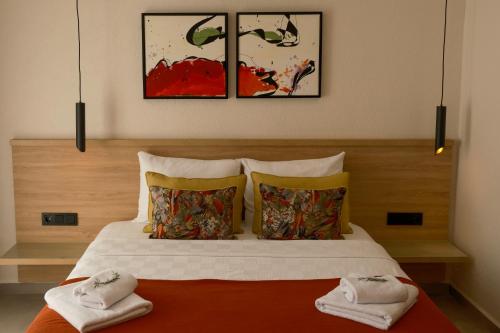 a bedroom with a bed with two towels on it at Uva Rooms in Fethiye